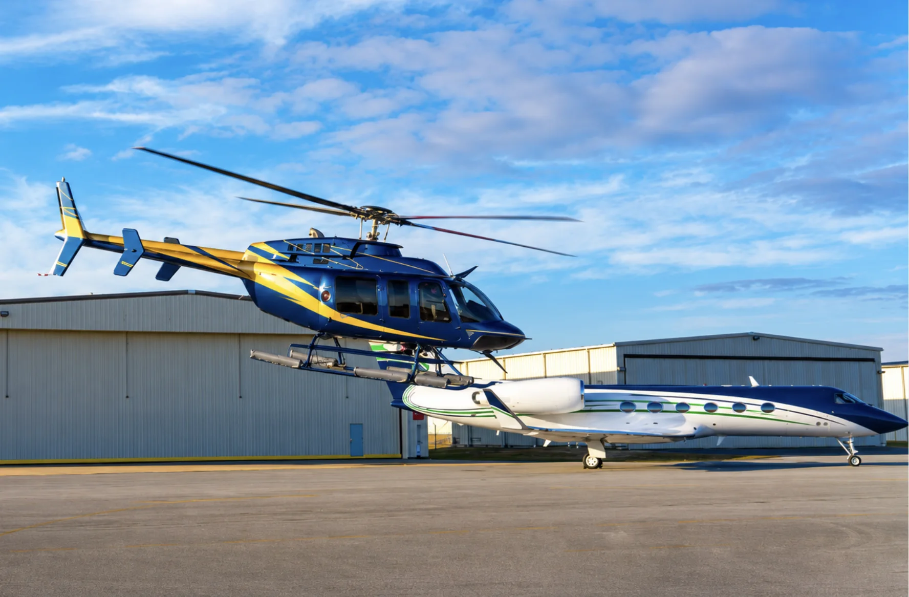 NexGen helicopter and private jet outside the company hangar