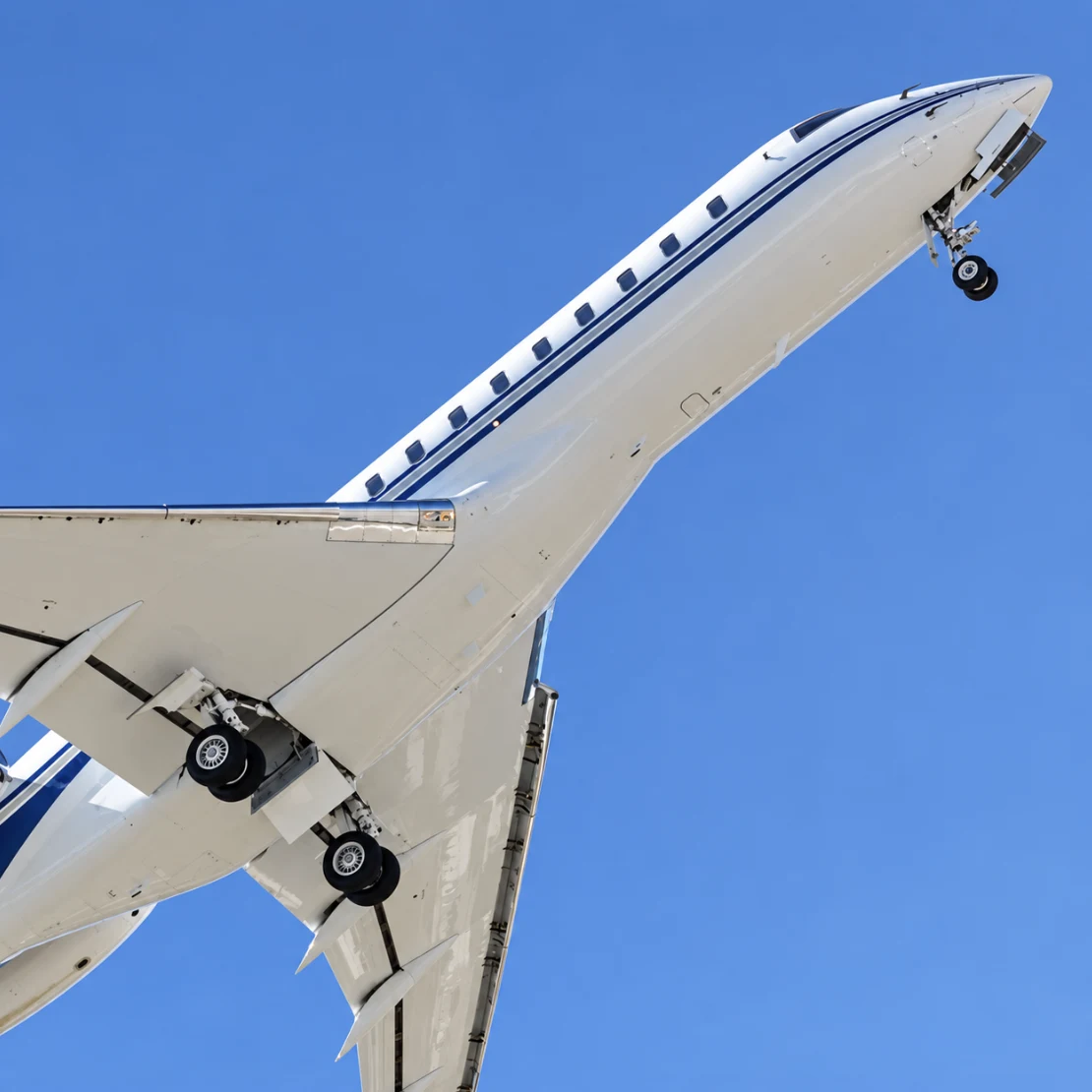 Private jet climbing into a clear blue sky