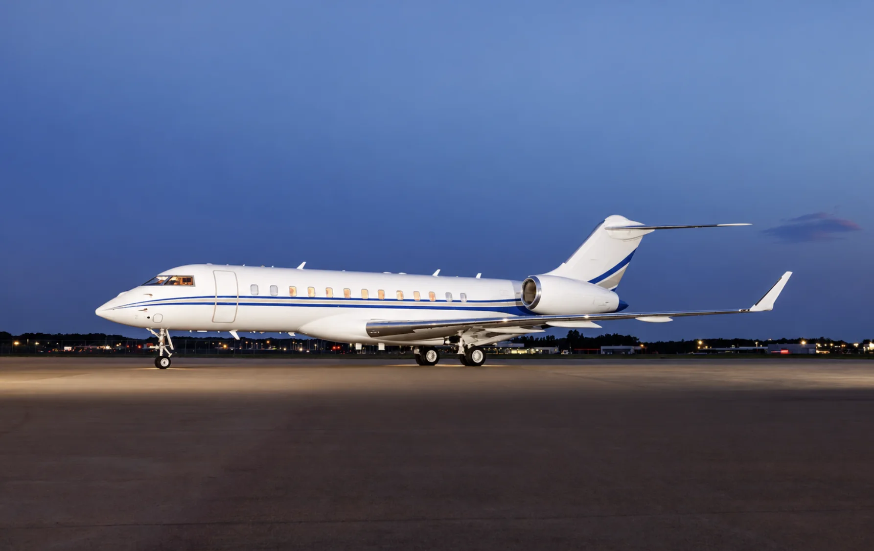 Private jet parked on the ramp at dusk