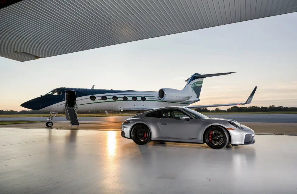 Private jet and Porsche on the ramp